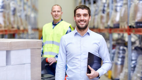 businessman with clipboard  over warehouse loader